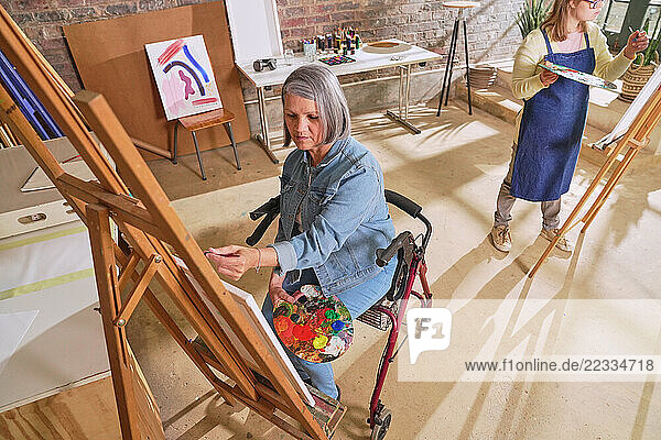 Disabled women painting in art studio