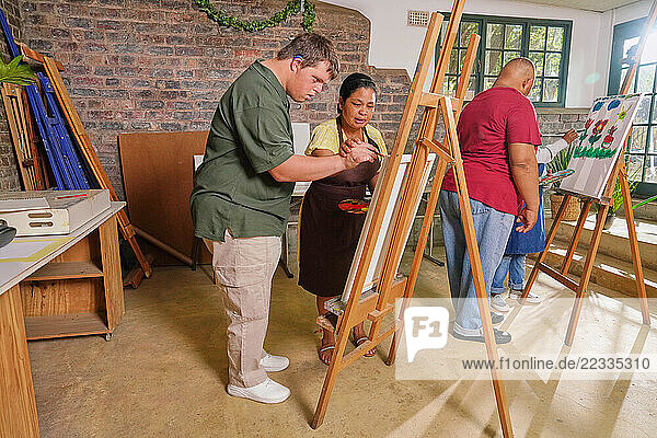 Disabled people painting during art classes