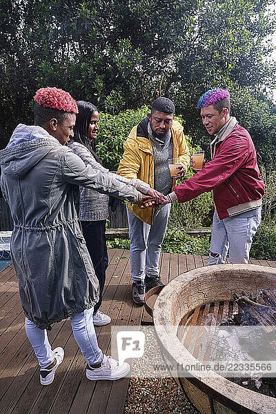 Friends stacking hands outdoors