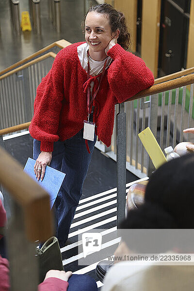 Smiling woman standing on stairs in community center