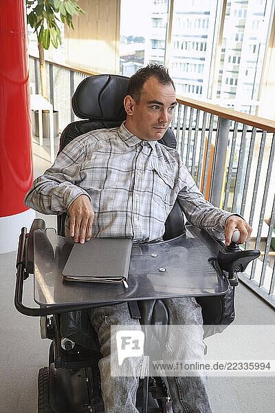 Man in wheelchair in office environment