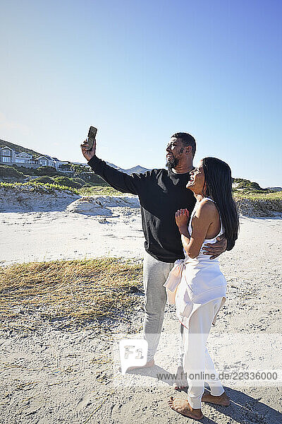 Friends taking selfie on beach