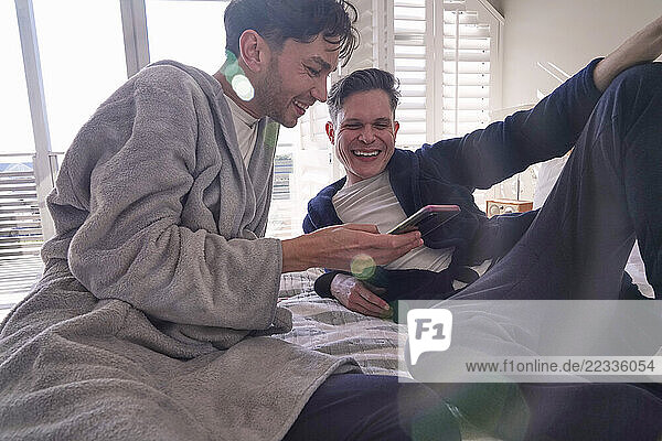 Happy gay couple on bed
