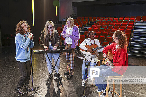 Friends playing and singing during rehearsal