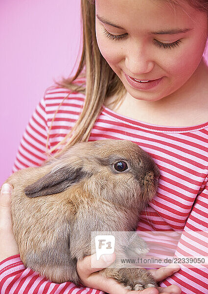 Young girl holding a rabbit