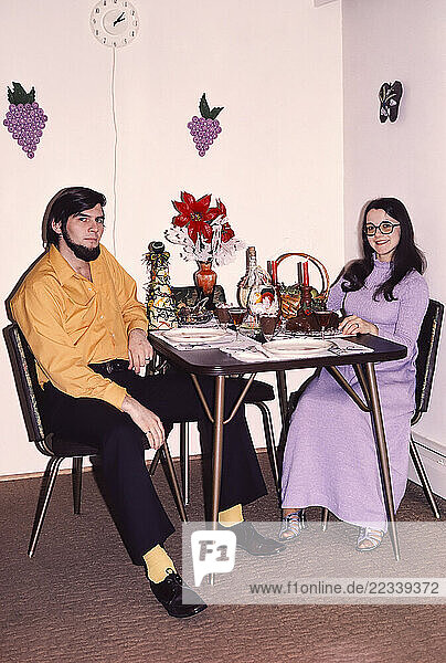 Portrait couple enjoying romantic Christmas dinner at dining table at home
