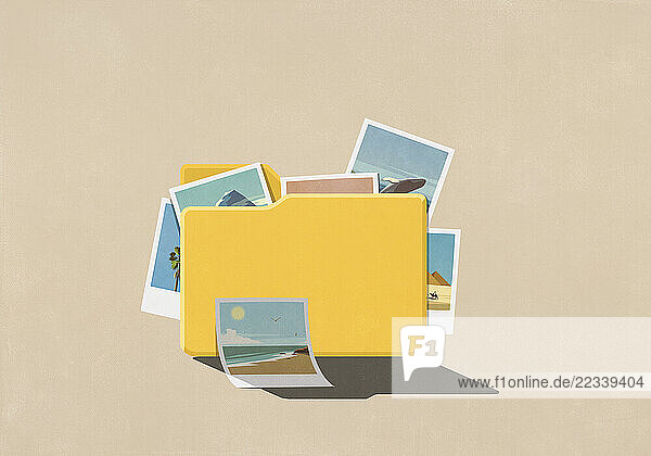Travel photos spilling from digital file folder on beige background