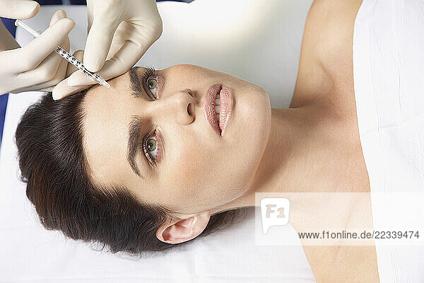 Woman Receiving Botox Injection on Forehead