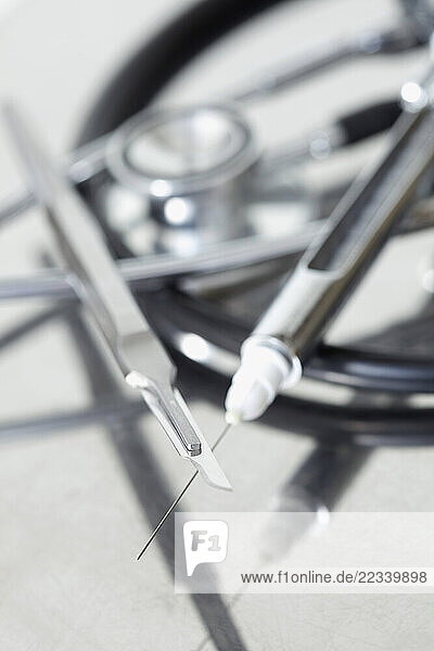 Close up of a Surgical Scalpel and Hypodermic Needle