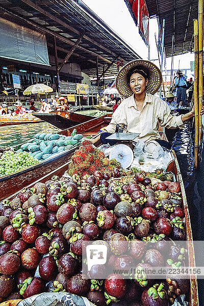 Vendor at the Damnoen Saduak floating market in Ratchaburi province  Thailand; Damnoen Saduak district  Ratchaburi Province  Thailand