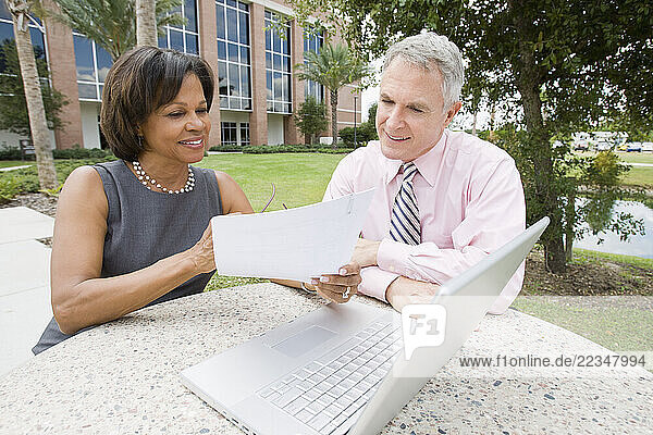 Business People with Laptop Outdoors