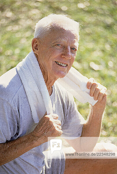 Portrait of Mature Man with Towel Around Neck Outdoors