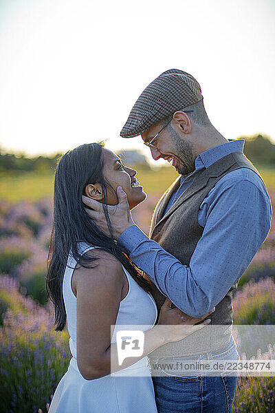 Young mixed race couple standing outdoors face to face in an affectionate pose; Woodenville  Washington  United States of America