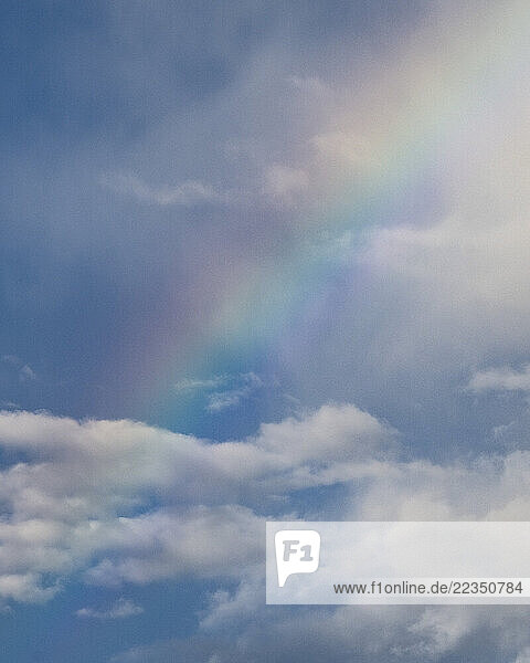 Rainbow in a sky with mist and clouds; Branxholm  Tasmania  Australia