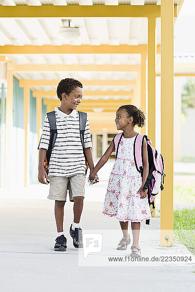 Brother and Sister Walking Together at School