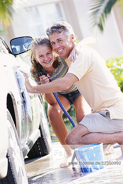 Father and Daughter Washing Car