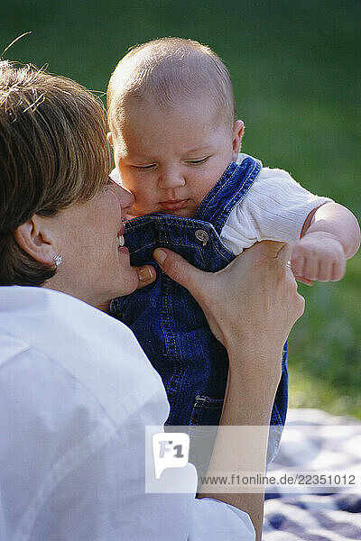 Mother Holding Baby Outdoors