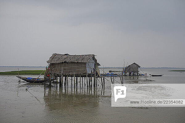 Houses flooded with high tide salt water at the Kalabogi village in Khulna  Bangladesh  on 31 August 2023. In the coastal areas of Southern Bangladesh like Kalabogi  people‘s livelihoods depend entirely on nature. Climate change has severe impacts on the natural environment. The consequences range from rising sea levels leading to salinization of soils and groundwater to erratic rainfall patterns and more frequent and destructive tropical cyclones. People living in coastal areas fight for their survival every day; Khula  Dhaka  Bangladesh