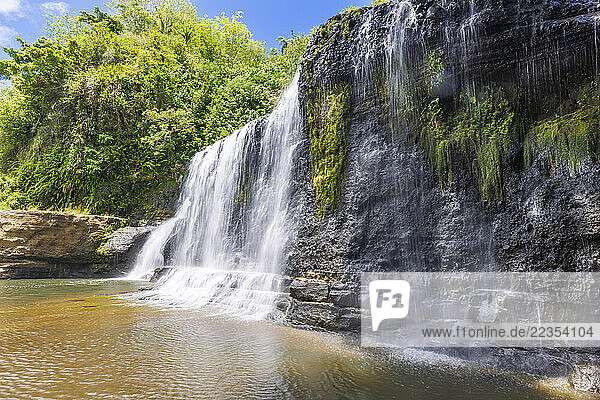 Landscape of Talofofo Falls  a waterfall with jungle and blue sky in the background  Inarajan  Guam  Micronesia  US Territory  Central Pacific Ocean; Inarajan  Guam  Mariana Islands  Micronesia