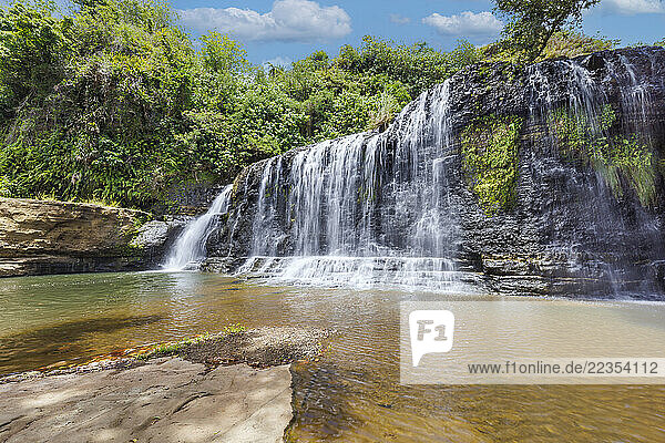 Landscape of Talofofo Falls  a waterfall with jungle and blue sky in the background  Inarajan  Guam  Micronesia  US Territory  Central Pacific Ocean; Inarajan  Guam  Mariana Islands  Micronesia