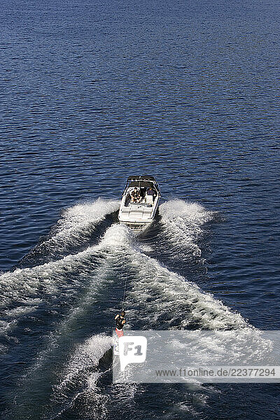 Sicamous  BC - Wakeboarders carve up Mara Lake  south of Sicamous  British Columbia  Canada. Part of the Shuswap Lake system  the area is called the houseboat capitol of Canada . An aerial image from helicopter.
