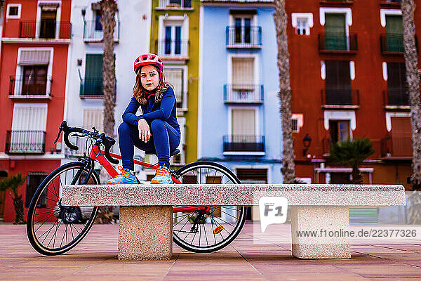 Boy with a bike on the beach promenade in Villajoyosa
