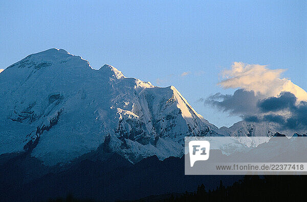 Towering 6 807 meters (22 334 feet) above sea level  Huascaran Mountain stands god-like over the town of Huaraz  Peru.