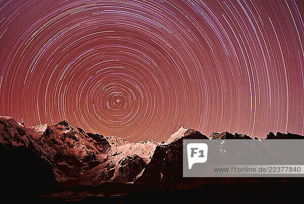A series of star trails circle around the bright North Star over Cho Oyo  one of the world s highest mountains  in Sagarmatha Naitonal Park  Nepal on December 20  2002. The moutain rangle separates Nepal from Tibet. (Photo By Dan Rafla/ Aurora)