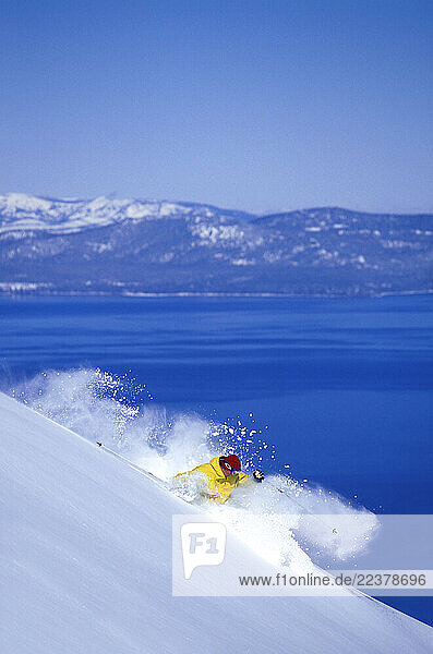 Richard Jameson making fresh tracks high above blue Lake Tahoe while skiing at Heavenly Mountain Resort in South Lake Tahoe  California.