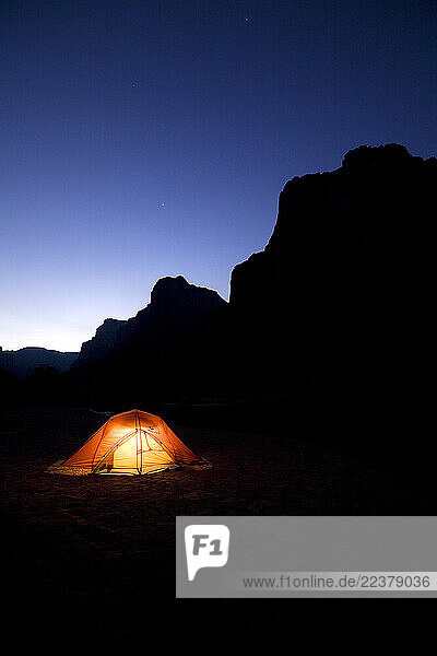 An illuminated tent sits in the Grand Canyon night in Arizona.