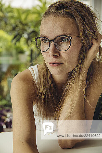Young woman with glasses looking sideways