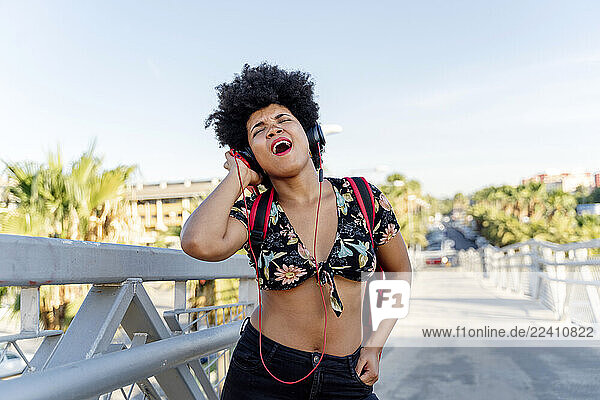 Female Afro-American with headphones listening music