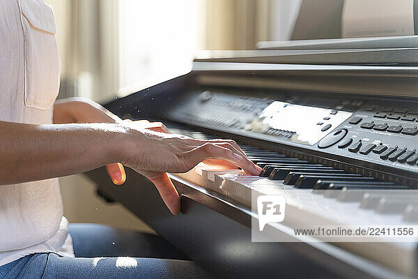 Close-up of woman playing piano
