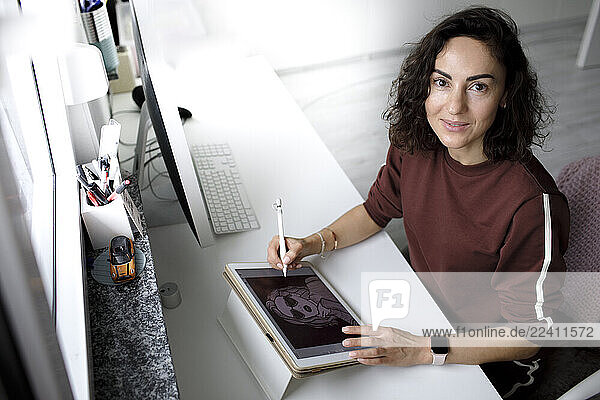 Female web designer using tablet at home