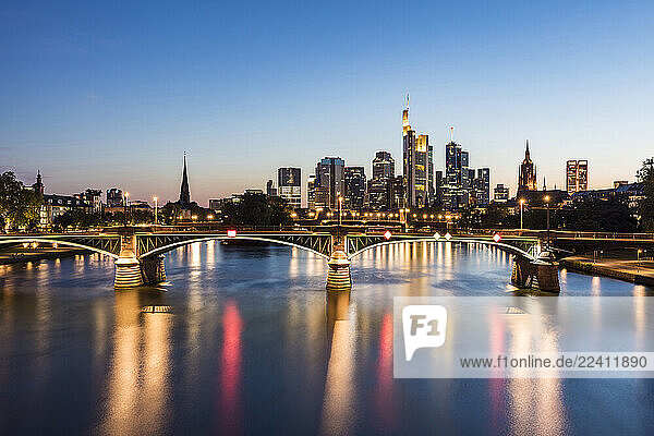Illuminated Ignatz Bubis Bridge over River Main against sky during dusk  Frankfurt  Germany