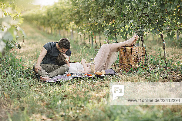 Young couple in love having picnic in the vineyards
