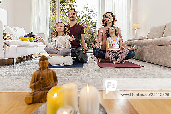 Family meditating together at home