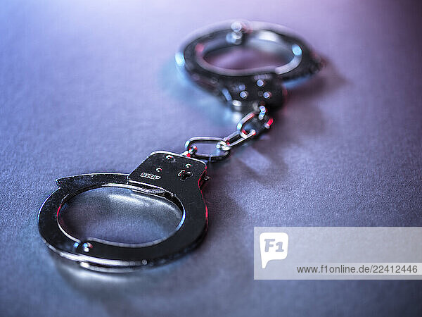 Close-up of metal handcuffs symbolizing justice and crime