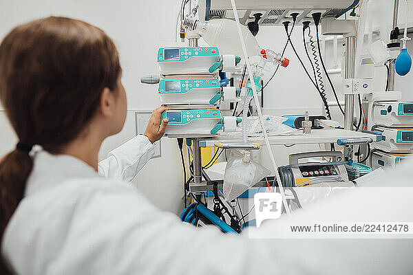 Doctor consulting with patient in emergency room with medical equipment