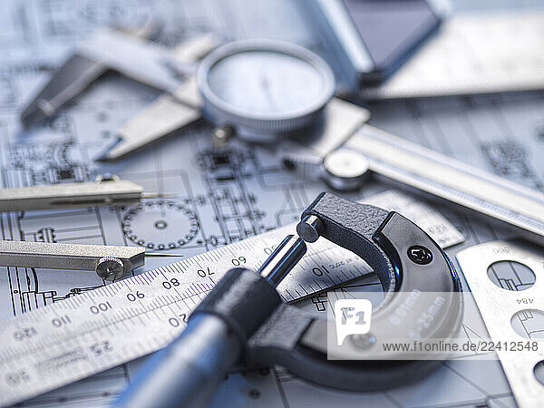 Close-up of engineering tools and blueprints for precision measurement and quality control