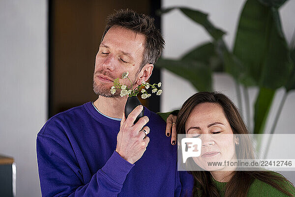 Two people enjoying tranquility with flowers in a café setting