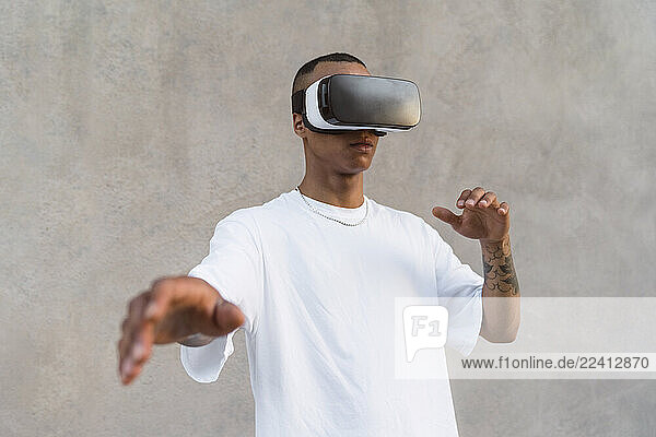 Tattooed young man using Virtual Reality Glasses