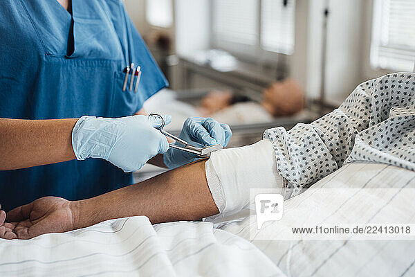 Doctor treating a patient s arm injury in a clinic