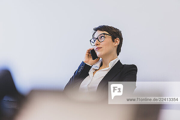 Young businesswoman on the phone at desk in office