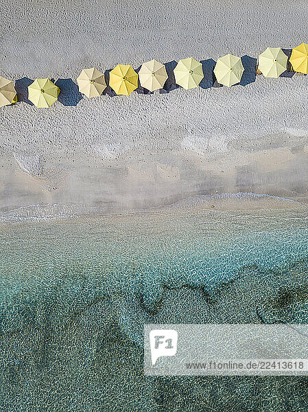 Aerial view of yellow parasols arranged at beach in Bali  Indonesia