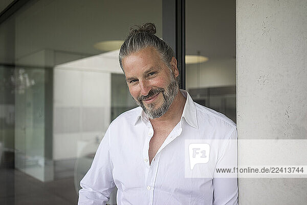 Portrait of smiling mature man at home