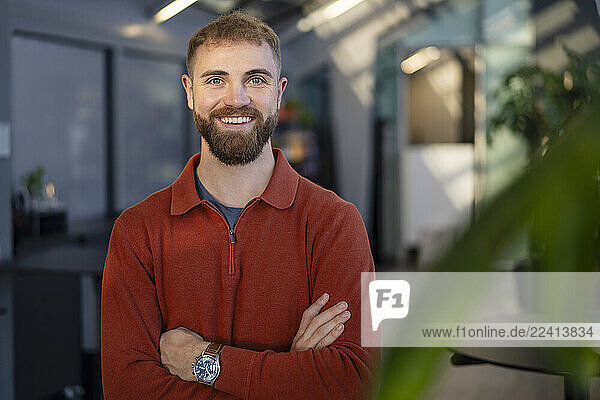 Young man smiling in a modern office environment