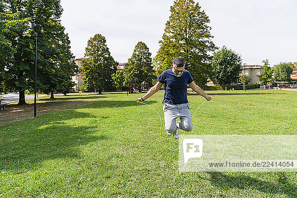 Man skipping rope in a park