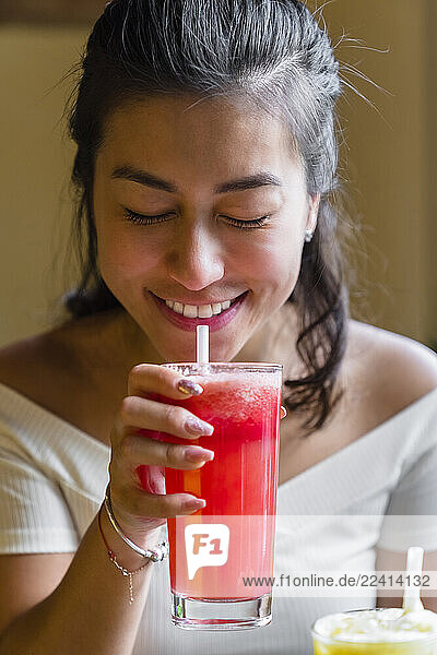 Young woman enjoying a smoothie