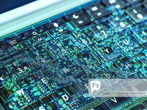 Futuristic view of a laptop keyboard with digital circuit overlay representing artificial intelligence and cybersecurity